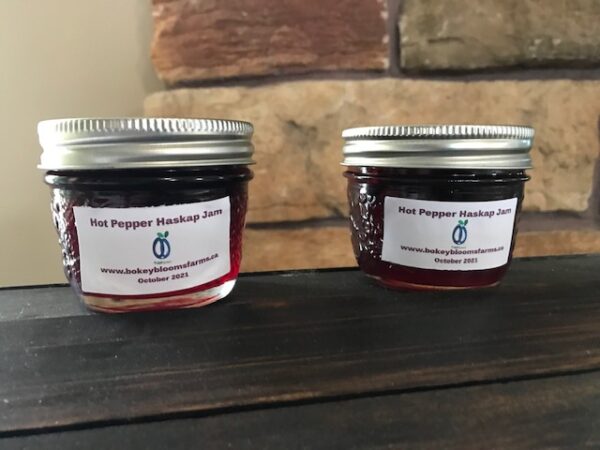 Jar of Bokey Bloom Farm Hot Pepper Haskap Jam made with prairie berries and spicy peppers.