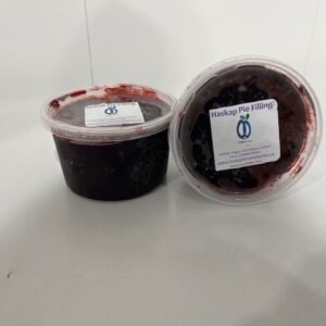 Container of deep purple haskap pie filling made from fresh haskap berries.